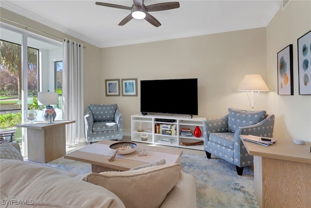 living room featuring ornamental molding and a ceiling fan