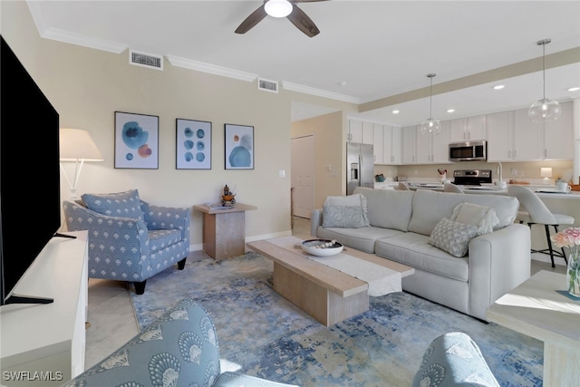 living area with ornamental molding, visible vents, and recessed lighting