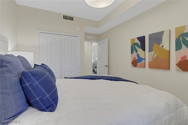 bedroom featuring a closet and visible vents