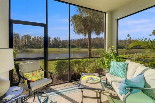 sunroom / solarium featuring a water view