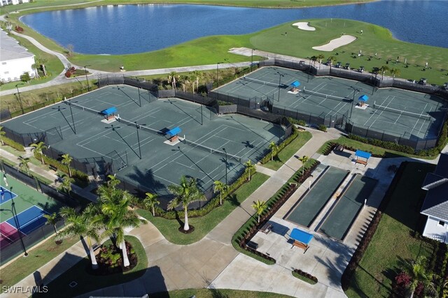 birds eye view of property with a water view and golf course view