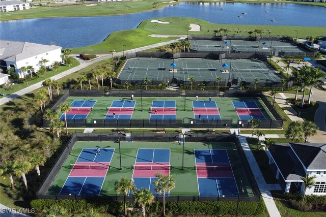 birds eye view of property with a water view and view of golf course