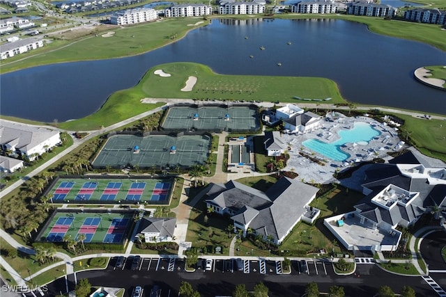 drone / aerial view featuring view of golf course and a water view