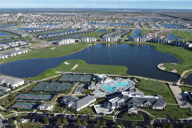 drone / aerial view featuring view of golf course and a water view