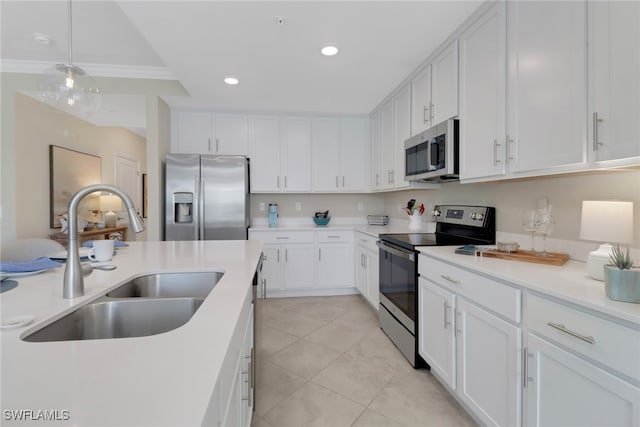 kitchen with white cabinets, appliances with stainless steel finishes, light countertops, a sink, and recessed lighting