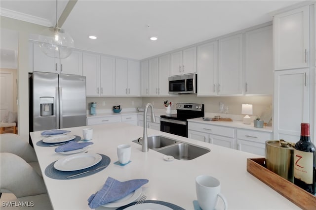 kitchen with a breakfast bar area, stainless steel appliances, light countertops, white cabinets, and a sink