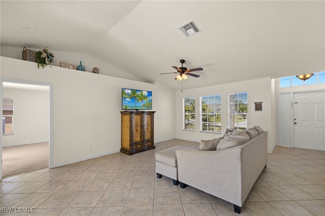 living room featuring visible vents, baseboards, vaulted ceiling, light tile patterned flooring, and a ceiling fan