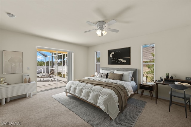 carpeted bedroom with access to exterior, multiple windows, and ceiling fan