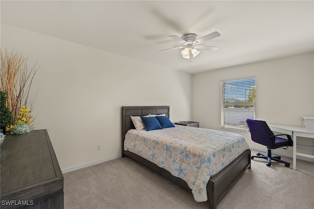 bedroom featuring baseboards, light colored carpet, and a ceiling fan