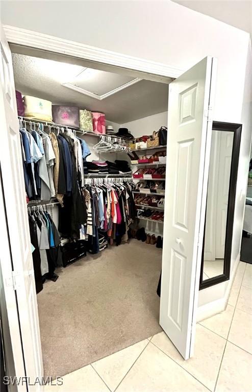 spacious closet featuring tile patterned flooring and carpet flooring