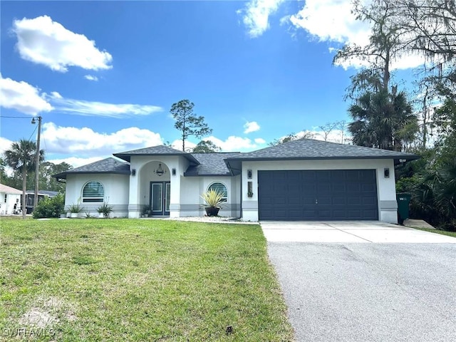 view of front of house with a front lawn, an attached garage, driveway, and stucco siding