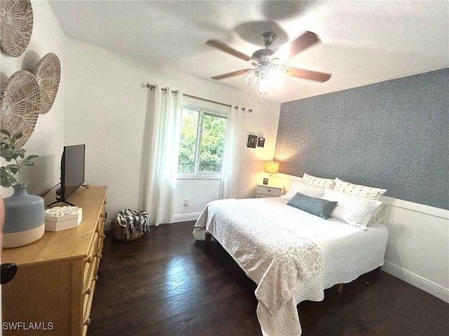 bedroom featuring dark wood-type flooring, baseboards, and ceiling fan