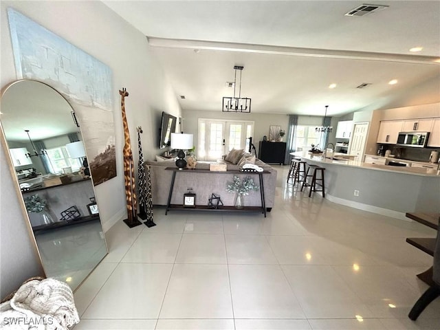 living room featuring light tile patterned floors, visible vents, baseboards, vaulted ceiling, and french doors