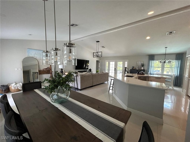 dining area featuring light tile patterned floors, visible vents, french doors, and arched walkways