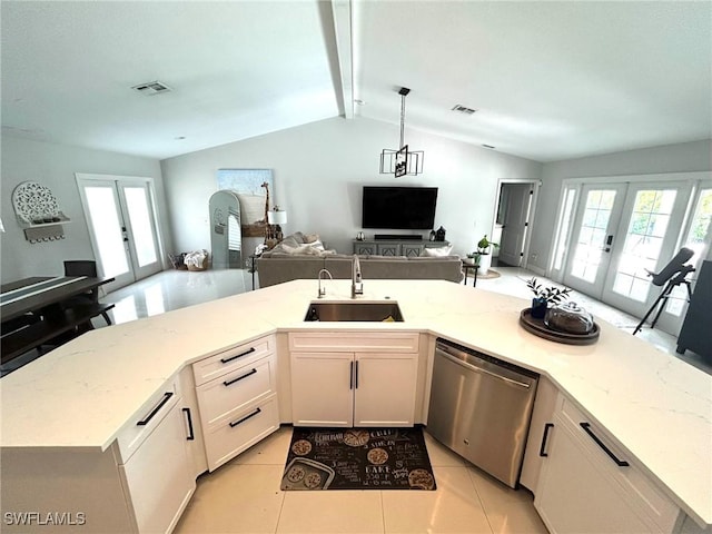 kitchen with open floor plan, french doors, stainless steel dishwasher, and a sink