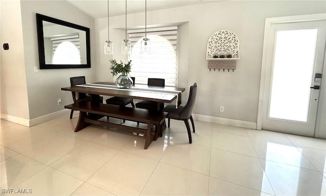 dining room with baseboards and light tile patterned flooring