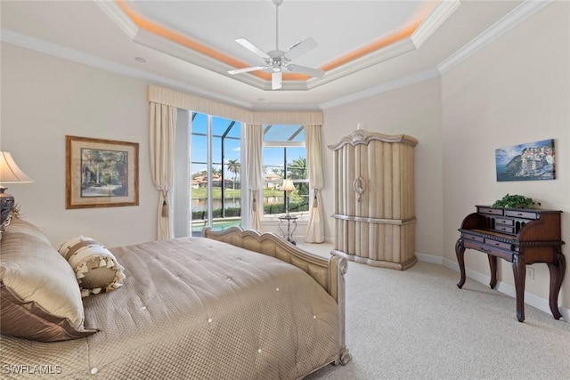 carpeted bedroom featuring a tray ceiling, access to outside, crown molding, and baseboards