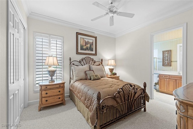 bedroom featuring crown molding, a closet, ensuite bathroom, a ceiling fan, and light carpet