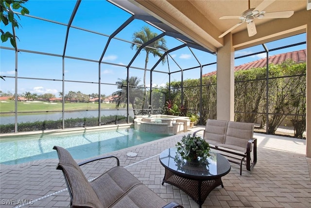 view of pool with ceiling fan, a lanai, a water view, a pool with connected hot tub, and a patio area