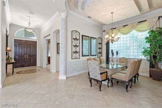 dining area featuring ornamental molding, a healthy amount of sunlight, visible vents, and an inviting chandelier