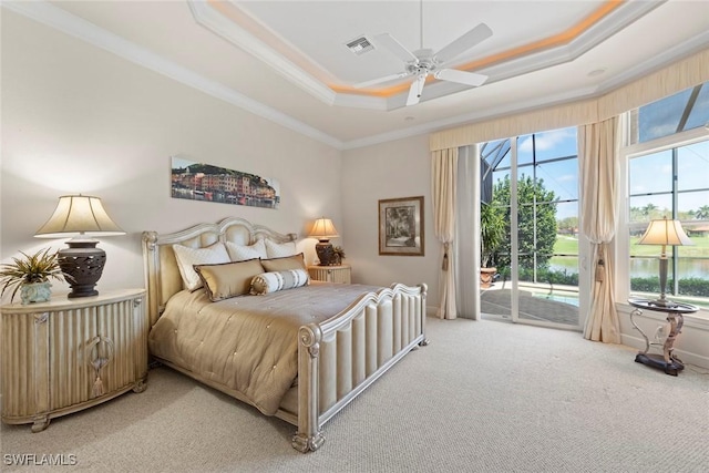 bedroom with access to exterior, a raised ceiling, visible vents, and multiple windows