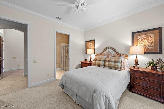 bedroom featuring baseboards, visible vents, arched walkways, light colored carpet, and crown molding