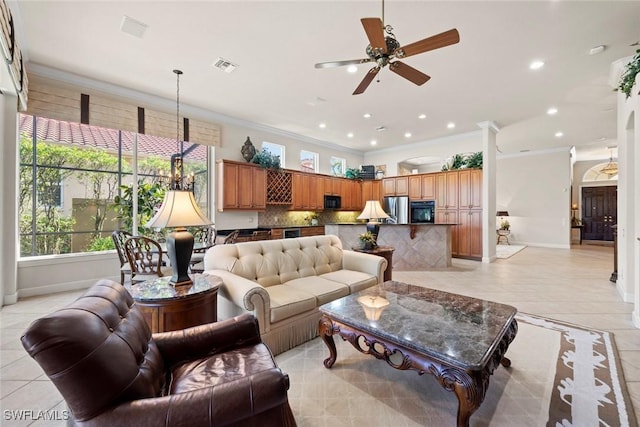 living room featuring light tile patterned floors, visible vents, and ornamental molding