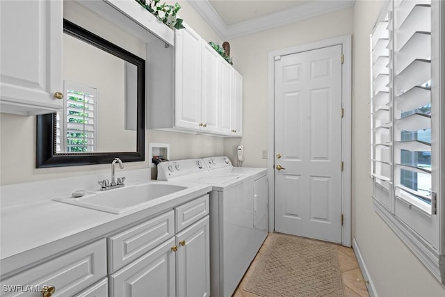 laundry area featuring cabinet space, light tile patterned floors, crown molding, washer and dryer, and a sink