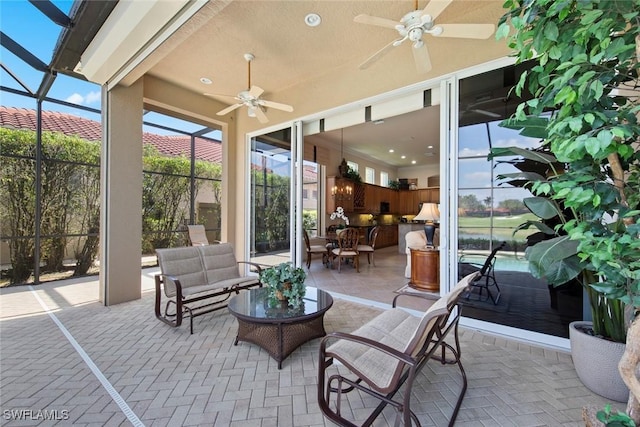 view of patio / terrace with ceiling fan, glass enclosure, and outdoor lounge area