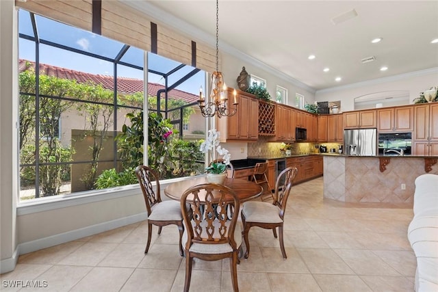 dining room with ornamental molding, a chandelier, baseboards, and light tile patterned floors