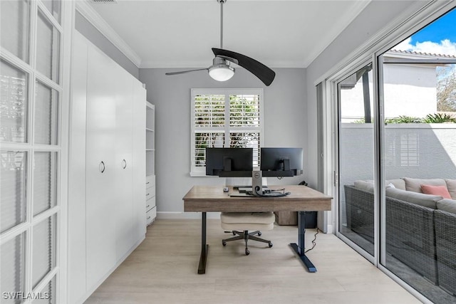 office area with ornamental molding, plenty of natural light, light wood finished floors, and a ceiling fan