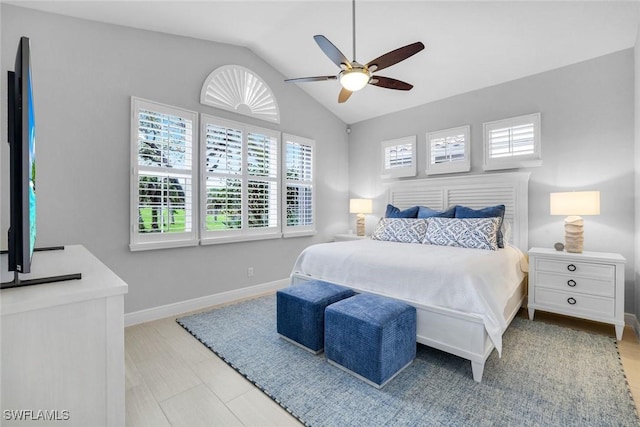 bedroom featuring a ceiling fan, lofted ceiling, and baseboards