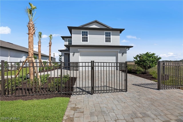 view of front of house with a garage, decorative driveway, and fence