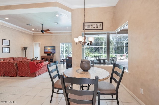 dining space with light tile patterned floors, ceiling fan with notable chandelier, baseboards, and crown molding