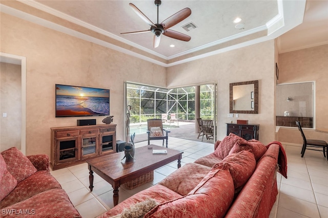 living room with visible vents, a ceiling fan, a sunroom, tile patterned floors, and crown molding