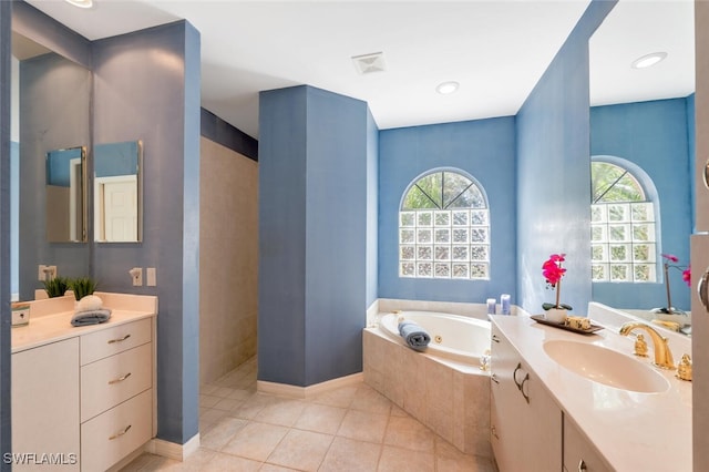 full bathroom featuring tile patterned flooring, a healthy amount of sunlight, a jetted tub, and a walk in shower