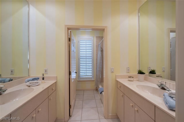 bathroom featuring tile patterned flooring, two vanities, and a sink