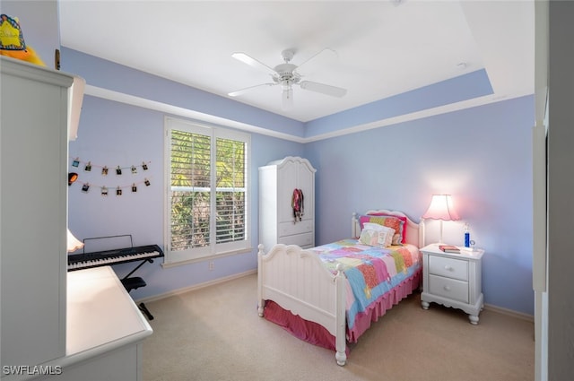 bedroom featuring ceiling fan, baseboards, and light colored carpet