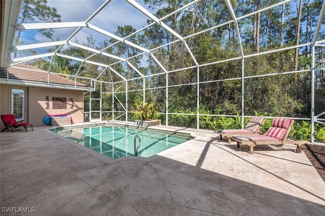 outdoor pool with a lanai and a patio area