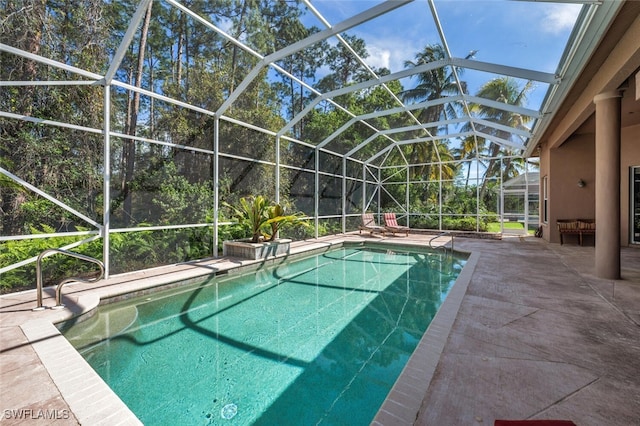 pool featuring glass enclosure and a patio