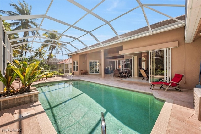 outdoor pool featuring a patio area and glass enclosure