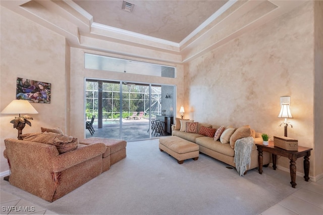 tiled living room with visible vents, baseboards, a towering ceiling, a sunroom, and crown molding