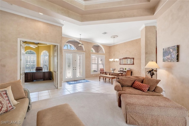 interior space with light carpet, a chandelier, french doors, and ornamental molding