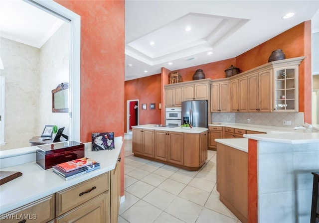 kitchen with light countertops, glass insert cabinets, stainless steel refrigerator with ice dispenser, and oven