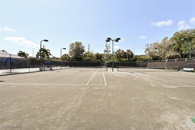 view of sport court featuring fence