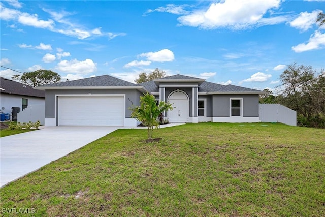 view of front facade featuring a front lawn, driveway, an attached garage, and stucco siding