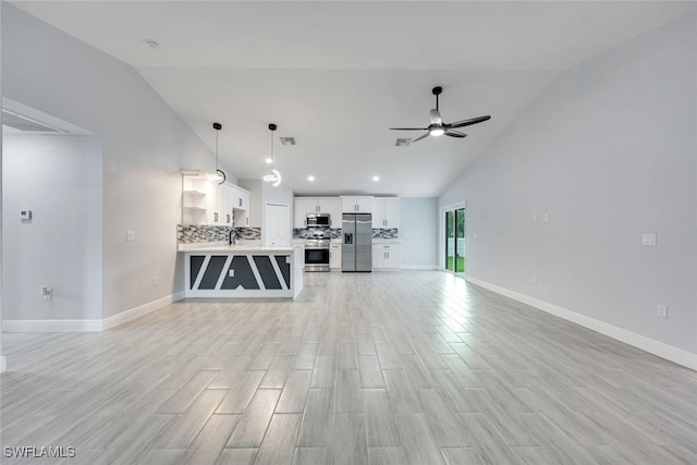 unfurnished living room with visible vents, ceiling fan, light wood-style flooring, and baseboards