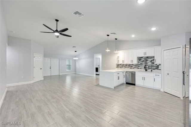 kitchen featuring a peninsula, visible vents, open floor plan, light countertops, and dishwasher