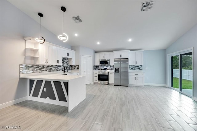 kitchen featuring stainless steel appliances, light countertops, visible vents, and open shelves