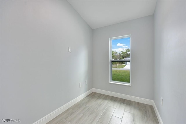 spare room with light wood-style flooring and baseboards